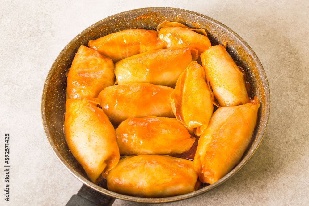 National Ukrainian dish - cabbage rolls with rice, meat wrapped cabbage on the pan National Ukrainian dish - cabbage rolls with rice, meat wrapped cabbage on the pan