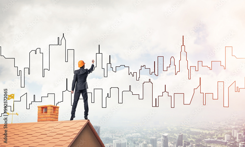 Man architect draw silhouette of modern city on blue sky. Mixed Man architect draw silhouette of modern city on blue sky. Mixed