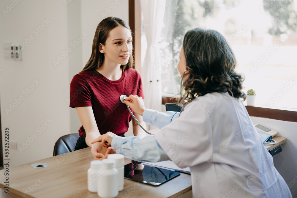 The doctor using a stethoscope checking patient with examining, Healthcare and medical concept.. The doctor using a stethoscope checking patient with examining, Healthcare and medical concept..