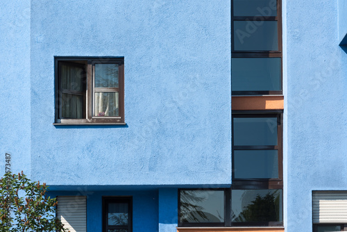 Brown window in a blue facade with beautiful geometric shapes