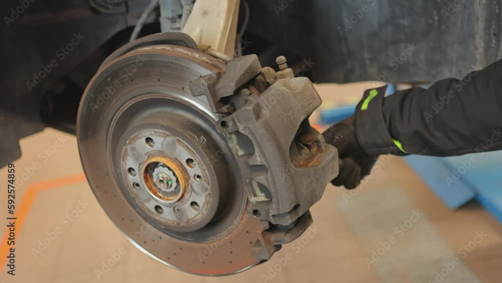 Mechanic Hands Replace Brake Pads on Car Mechanic Hands Replace Brake Pads on Car