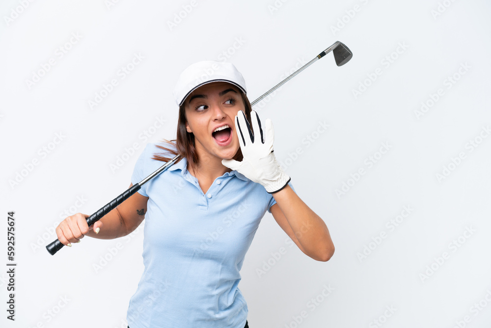 Young caucasian woman playing golf isolated on white background shouting with mouth wide open to the side Young caucasian woman playing golf isolated on white background shouting with mouth wide open to the side