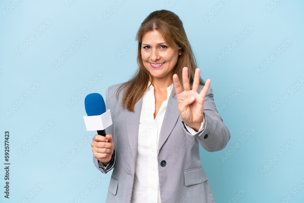 Middle-aged TV presenter woman over isolated blue background happy and counting four with fingers Middle-aged TV presenter woman over isolated blue background happy and counting four with fingers