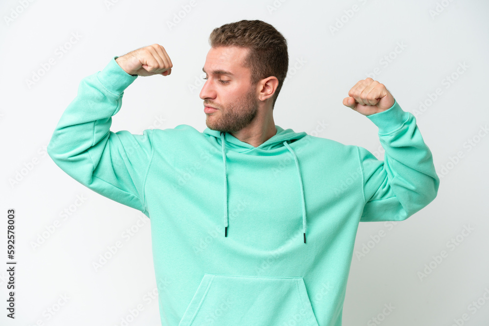 Young handsome caucasian man isolated on white background doing strong gesture Young handsome caucasian man isolated on white background doing strong gesture