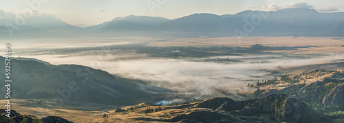 Mountain valley in fog, morning light