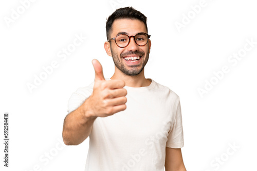 Young handsome caucasian man over isolated chroma key background with thumbs up because something good has happened