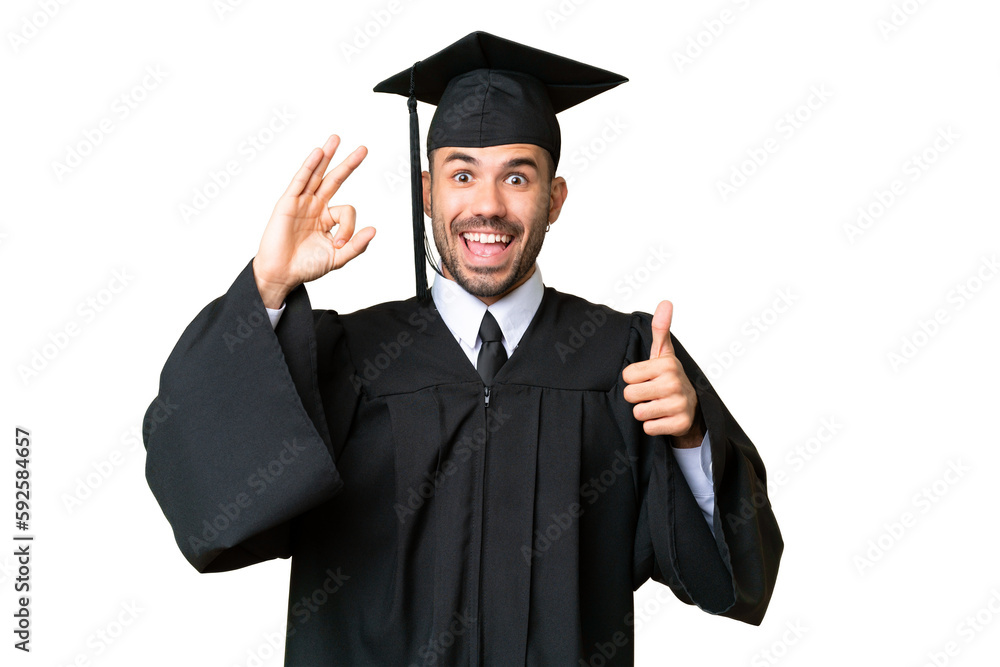 Young university graduate man over isolated chroma key background showing ok sign and thumb up gesture Young university graduate man over isolated chroma key background showing ok sign and thumb up gesture