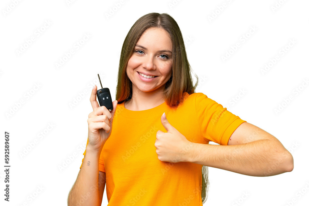 Young woman holding car keys over isolated chroma key background with thumbs up because something good has happened Young woman holding car keys over isolated chroma key background with thumbs up because something good has happened