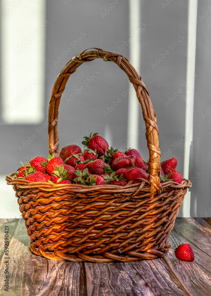 A basket with strawberries close-up on the table. A basket with strawberries close-up on the table.