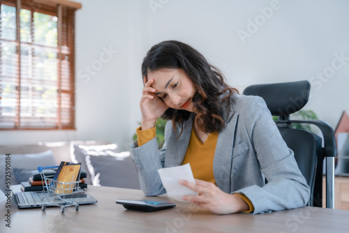 Women working with calculator, business document and laptop computer notebook.