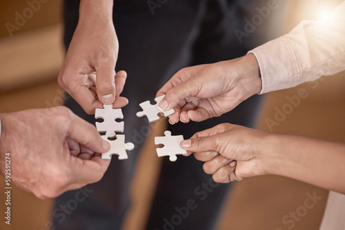 Business people, hands and puzzle piece in planning, collaboration or teamwork brainstorming at the office. Hand of group in team building, strategy or activity for engagement, support or interaction