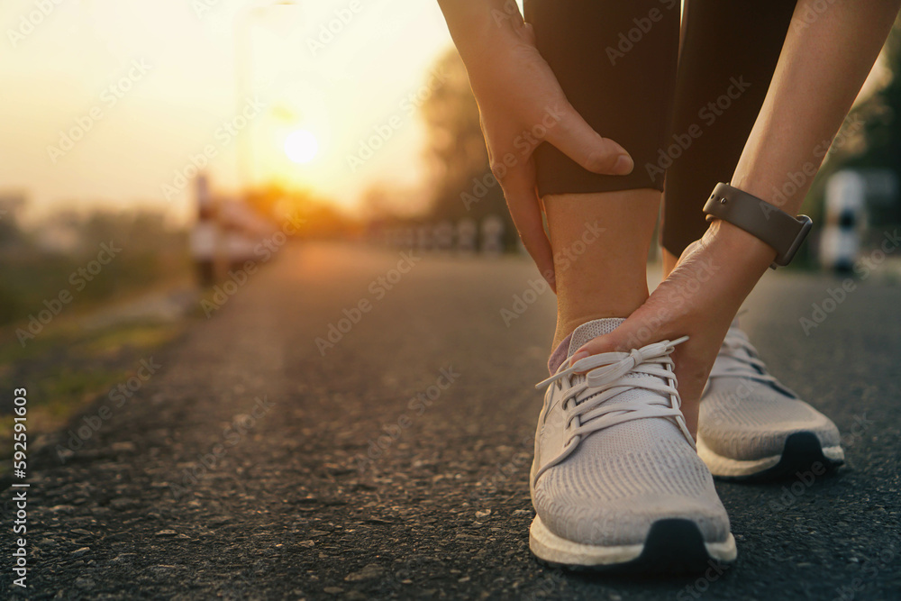 Ankle twist sprain accident in sport exercise running jogging.low key lighting. Ankle twist sprain accident in sport exercise running jogging.low key lighting.
