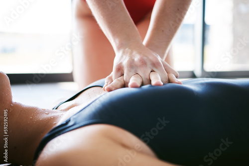 Cpr, hands and chest compression for swimming emergency, drowning and accident with lifeguard. Sports, breathing and resuscitation of woman, rescue of athlete and saving life of swimmer at pool.