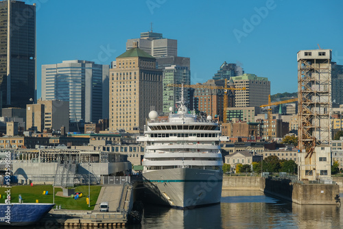 Luxury cruiseship cruise ship liner Amera with downtown Montreal, Canada skyline during New England Indian summer cruising on sunny day © Tamme