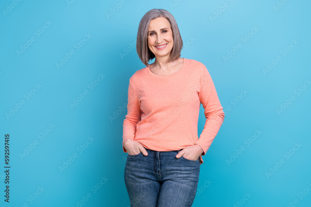 Photo of retired model business worker lady put hands pockets denim jeans stylish office style outfit secretary isolated on blue color background Photo of retired model business worker lady put hands pockets denim jeans stylish office style outfit secretary isolated on blue color background