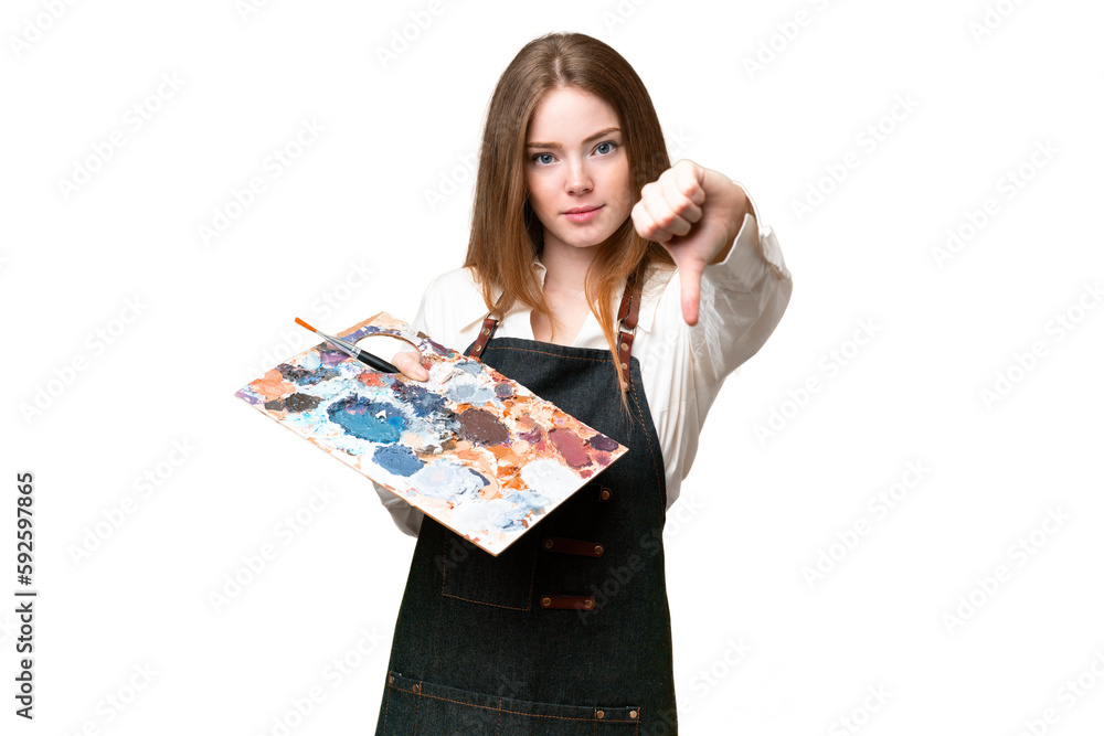 Young artist woman holding a palette over isolated chroma key background showing thumb down with negative expression Young artist woman holding a palette over isolated chroma key background showing thumb down with negative expression