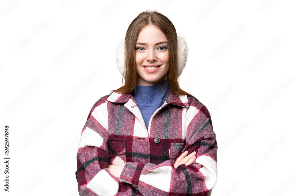 Young pretty woman wearing winter muffs over isolated chroma key background keeping the arms crossed in frontal position Young pretty woman wearing winter muffs over isolated chroma key background keeping the arms crossed in frontal position