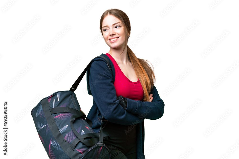 Young sport woman with sport bag over isolated chroma key background with arms crossed and happy Young sport woman with sport bag over isolated chroma key background with arms crossed and happy