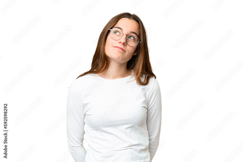 Teenager girl over isolated chroma key background and looking up Teenager girl over isolated chroma key background and looking up