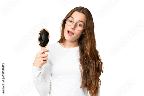Teenager girl with hair comb over isolated chroma key background with surprise and shocked facial expression
