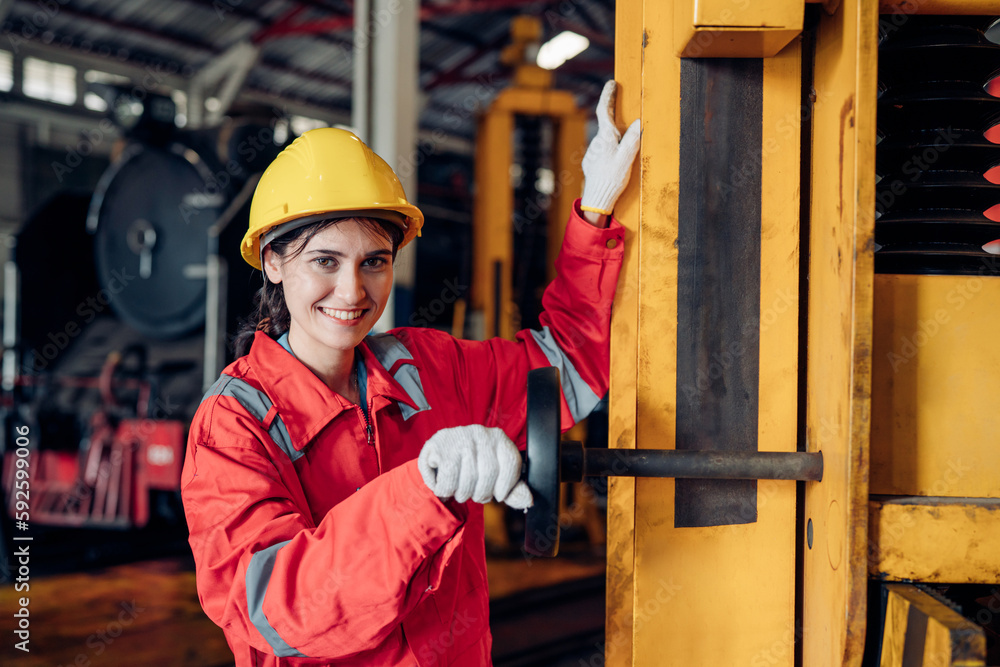 Portrait of woman engineer standing and looking camera in train factory. Maintenance cycle concept. Portrait of woman engineer standing and looking camera in train factory. Maintenance cycle concept.