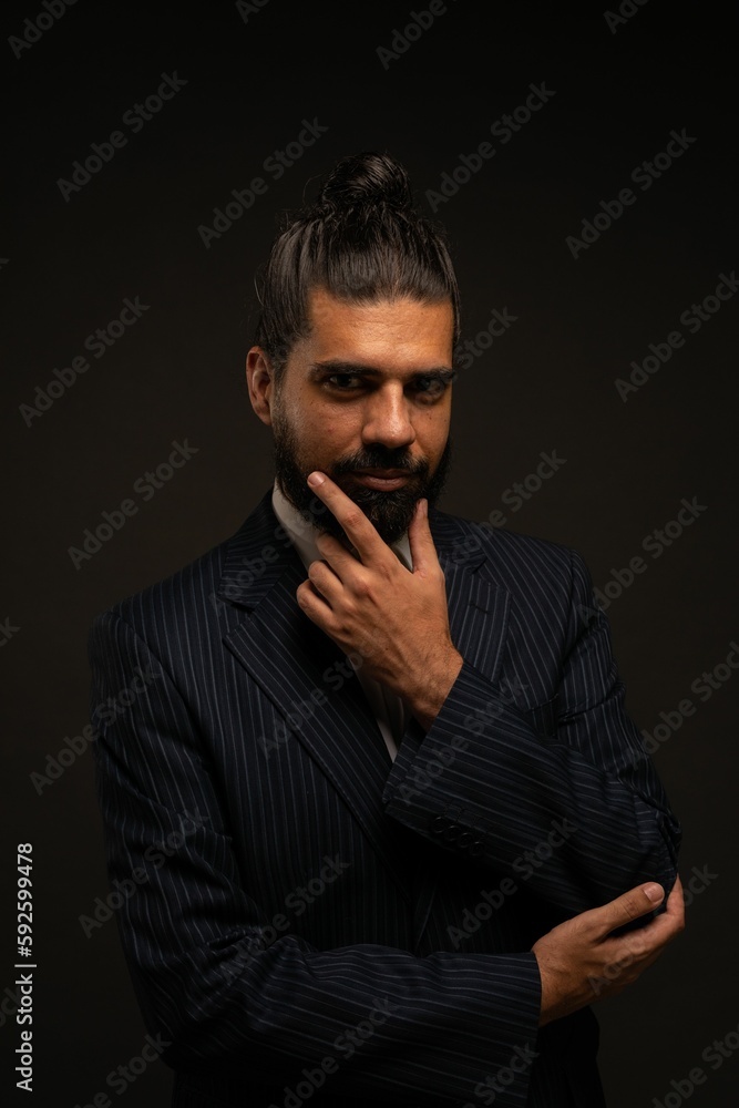 Beautiful shot of a Hispanic man showing emotions in front of a black background Beautiful shot of a Hispanic man showing emotions in front of a black background