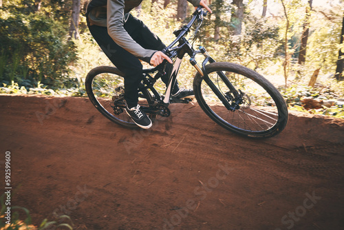 Fitness, bicycle workout and man outdoor on a forest path with extreme and exercise adventure. Bike, cycling and sport of an athlete with fast speed and nature hill for sports training and action © Azeemud/peopleimages.com