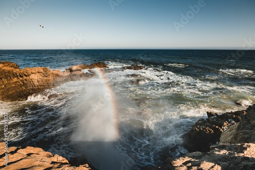 Beautiful seascape view with cliffs and a rainbow in Malibu California