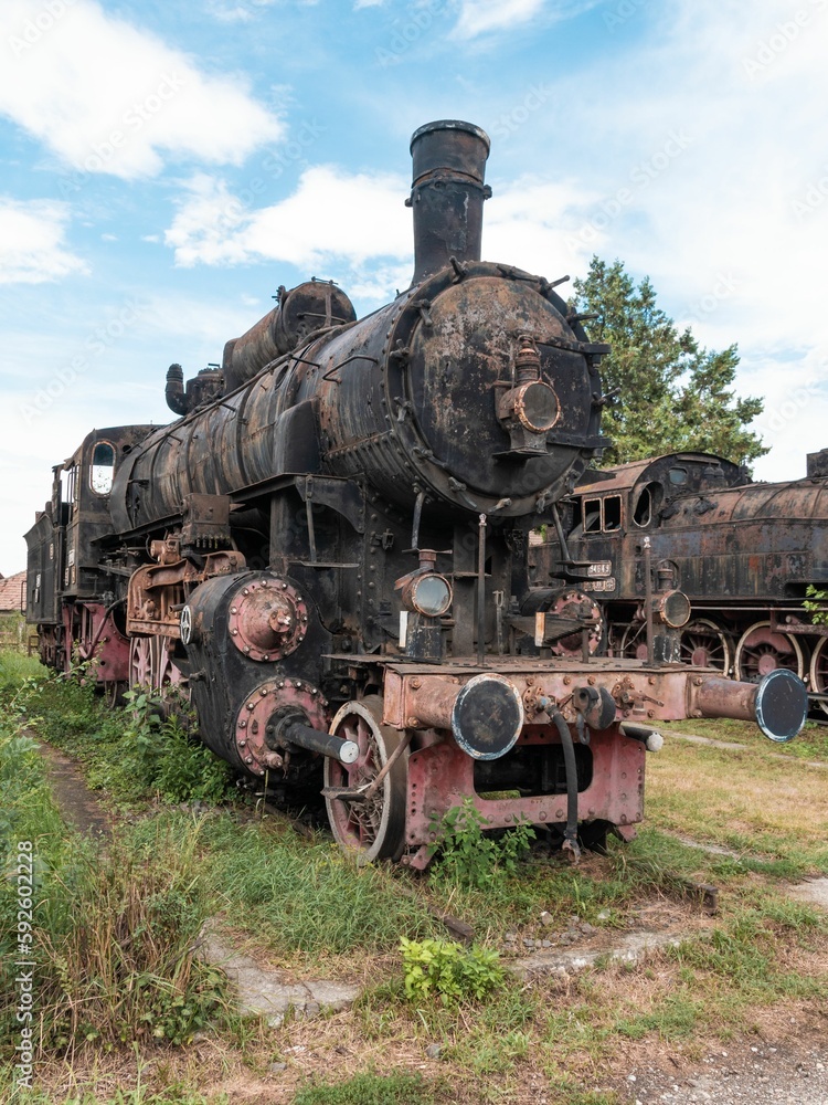 Vertical shot of steamed locomotive in a junkyard