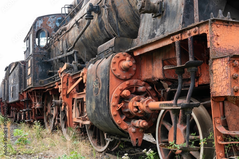 Old steamed locomotive in a junkyard