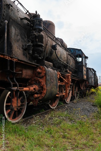 Vertical shot of steamed locomotive in a junkyard