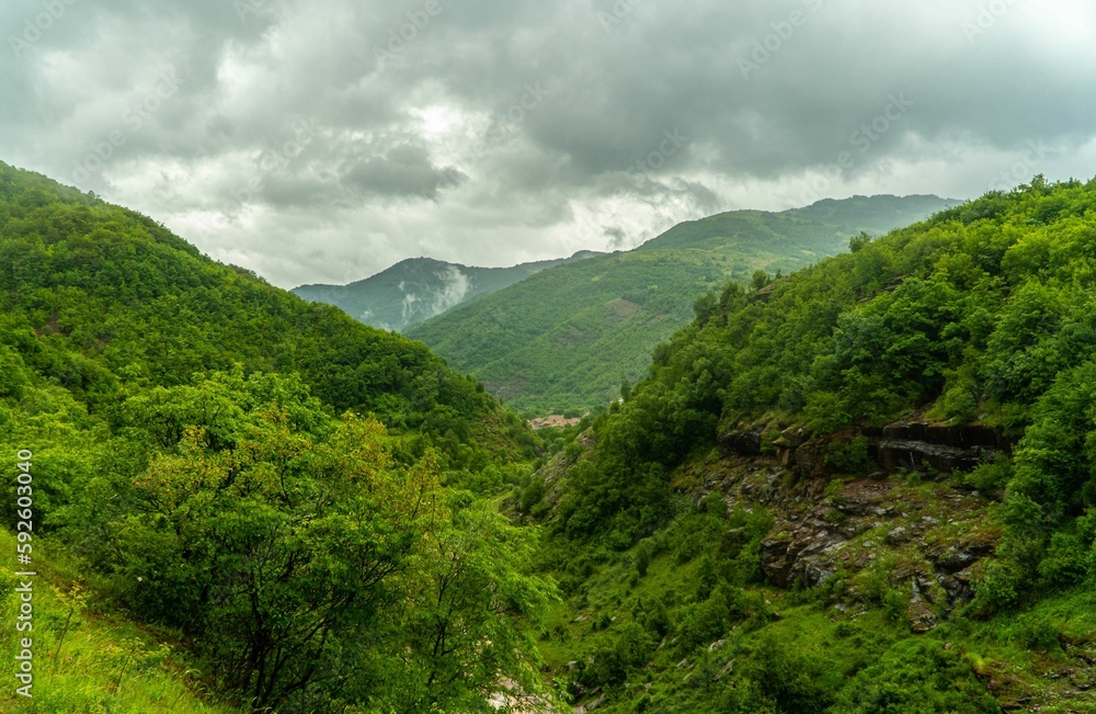 Landscape view of the green hills against a clouded sky Landscape view of the green hills against a clouded sky