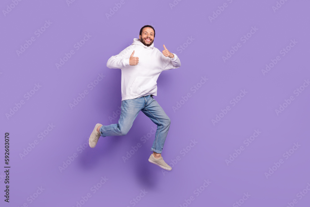Full length photo of youngster funny handsome man wear jeans hoodie thumbs up rate product placement isolated on violet color background