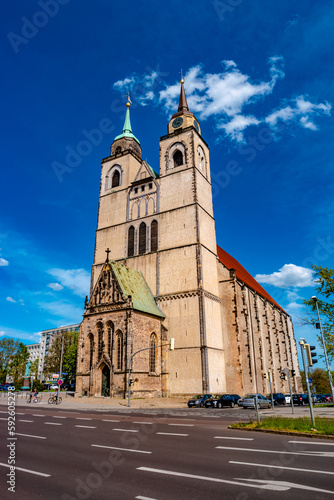 Church of Saint Jochannis, Jochanniskirche, in front of highway street in historical downtown of Magdeburg at blue Spring sky