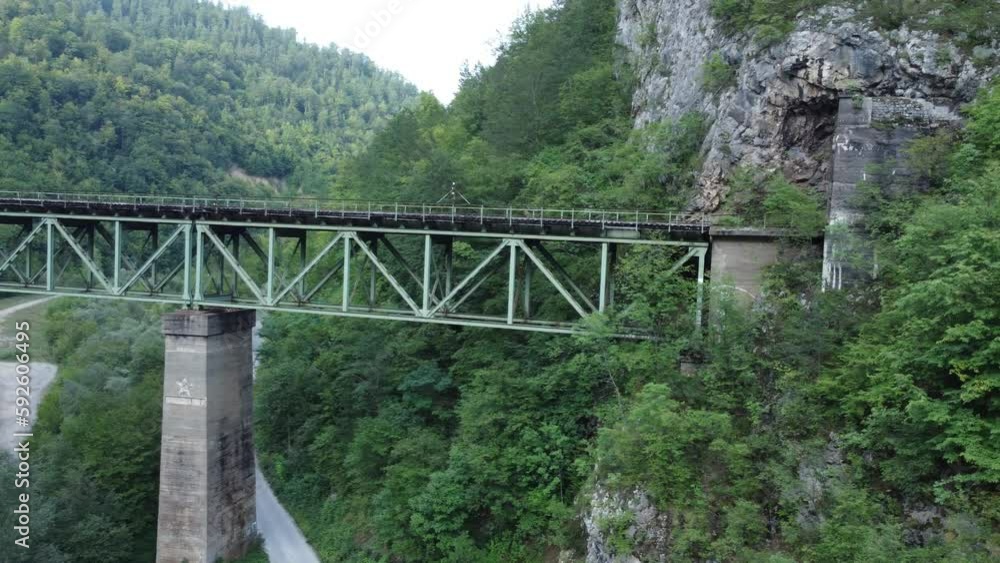 Drone view of an old railway bridge connected to a tunnel on a mountain Drone view of an old railway bridge connected to a tunnel on a mountain