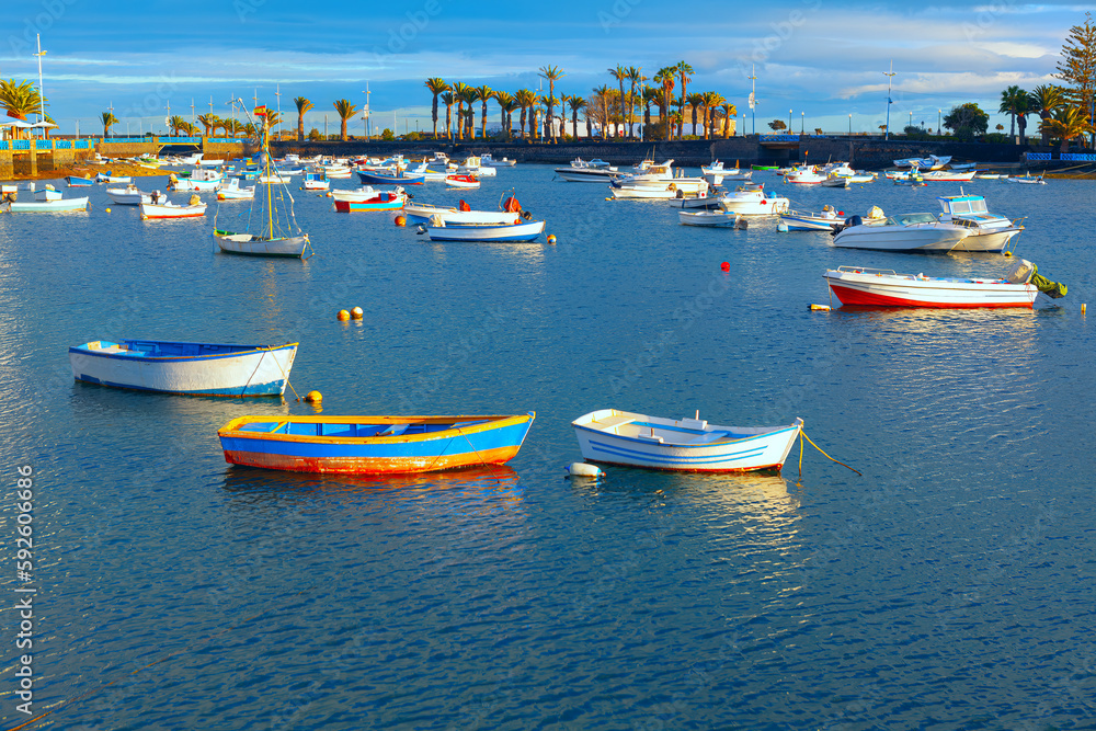 Lagoon with wooden boats . Arrecife water bay in Lanzarote