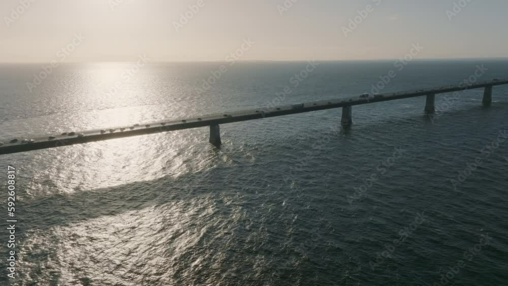 Storebæltsbroen Bridge at sunset, with a flow of coastal traffic on the roadway
