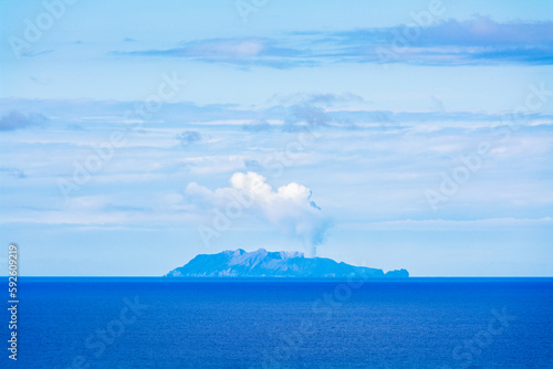 Whakaari/White Island is an active marine volcano that is located 49 kilometres offshore from Whakatane. View from Kohi Point Lookout, Whakatane, New Zealand photo