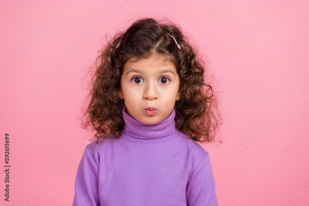 Photo of impressed funky little child dressed purple pullover sending you lips kiss isolated pink color background Photo of impressed funky little child dressed purple pullover sending you lips kiss isolated pink color background