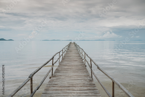 Picturesque scenery of empty wooden pier placed on rippling sea under cloudy sky