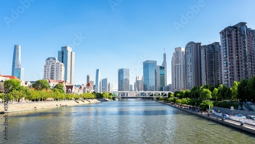 Beautiful shot of modern city architectures with a river view and blue sky