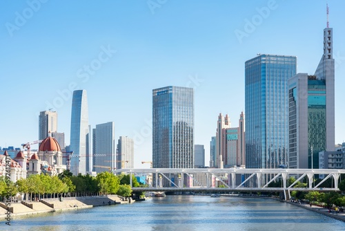 Beautiful shot of modern city skyline with a river view and blue sky