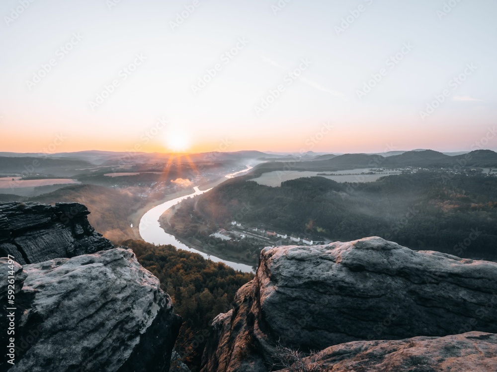 Beautiful shot from the edge of a cliff to a river during the sunset