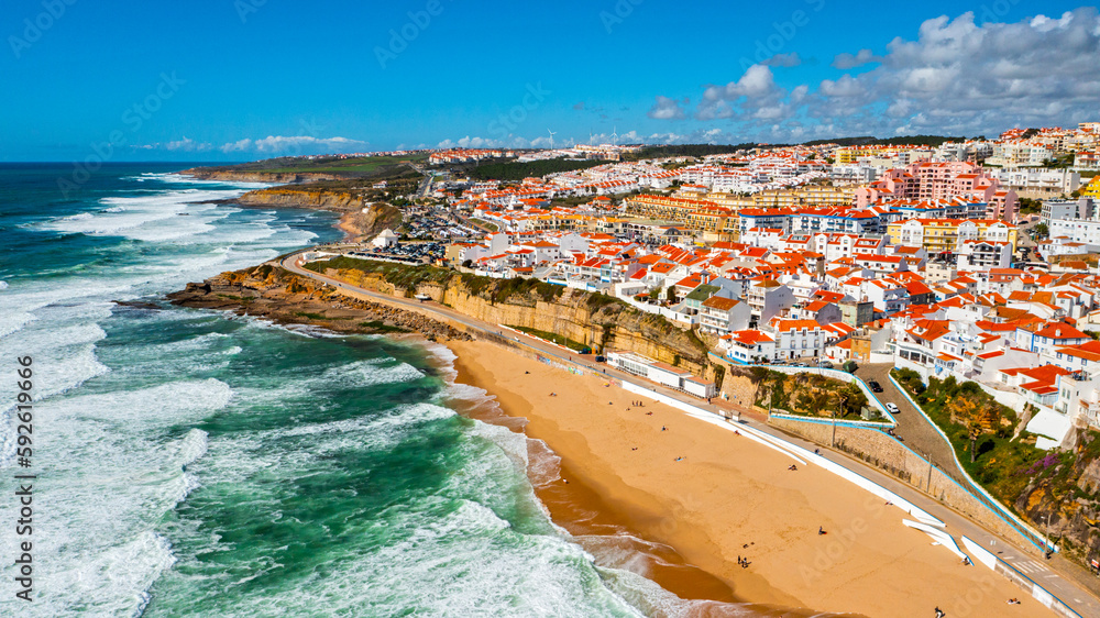Aerial view of a beautiful tourist town located on the sandy beach of the Atlantic Ocean.  Panorama of the city from drone with a  rocky ocean coastline. Scenic cityscape from drone on ocean coast
