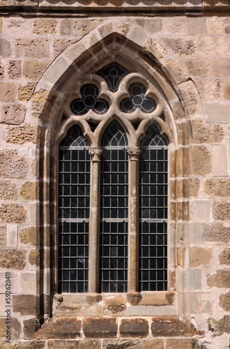 Pointed gothic window arch with trefoil tracery at St Martini church in the old town of Halberstadt, Sachsen-Anhalt region in Germany