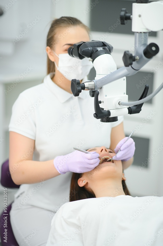 Beautiful young woman having dental treatment at dentist's office. Beautiful young woman having dental treatment at dentist's office.