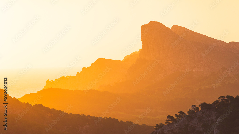 Orange sunset in mountains.