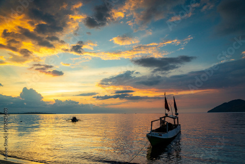 fisherman boat shilloute at sunset view