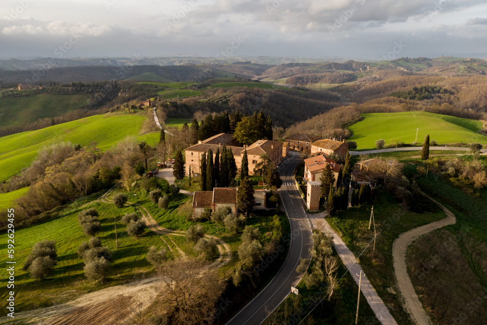 Italian countryside scenery featuring a hilltop residence in Tuscany. Italian countryside scenery featuring a hilltop residence in Tuscany.
