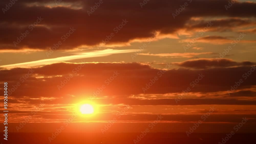 Sunrise sky with red light of the sun, timelapse. Morning clouds in the orange light of sun rays Sunrise sky with red light of the sun, timelapse. Morning clouds in the orange light of sun rays